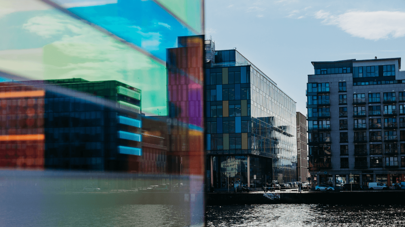 Image showing glass buildings in an industrial tech area, representing the acquisition of Okens Domains by Ilkari